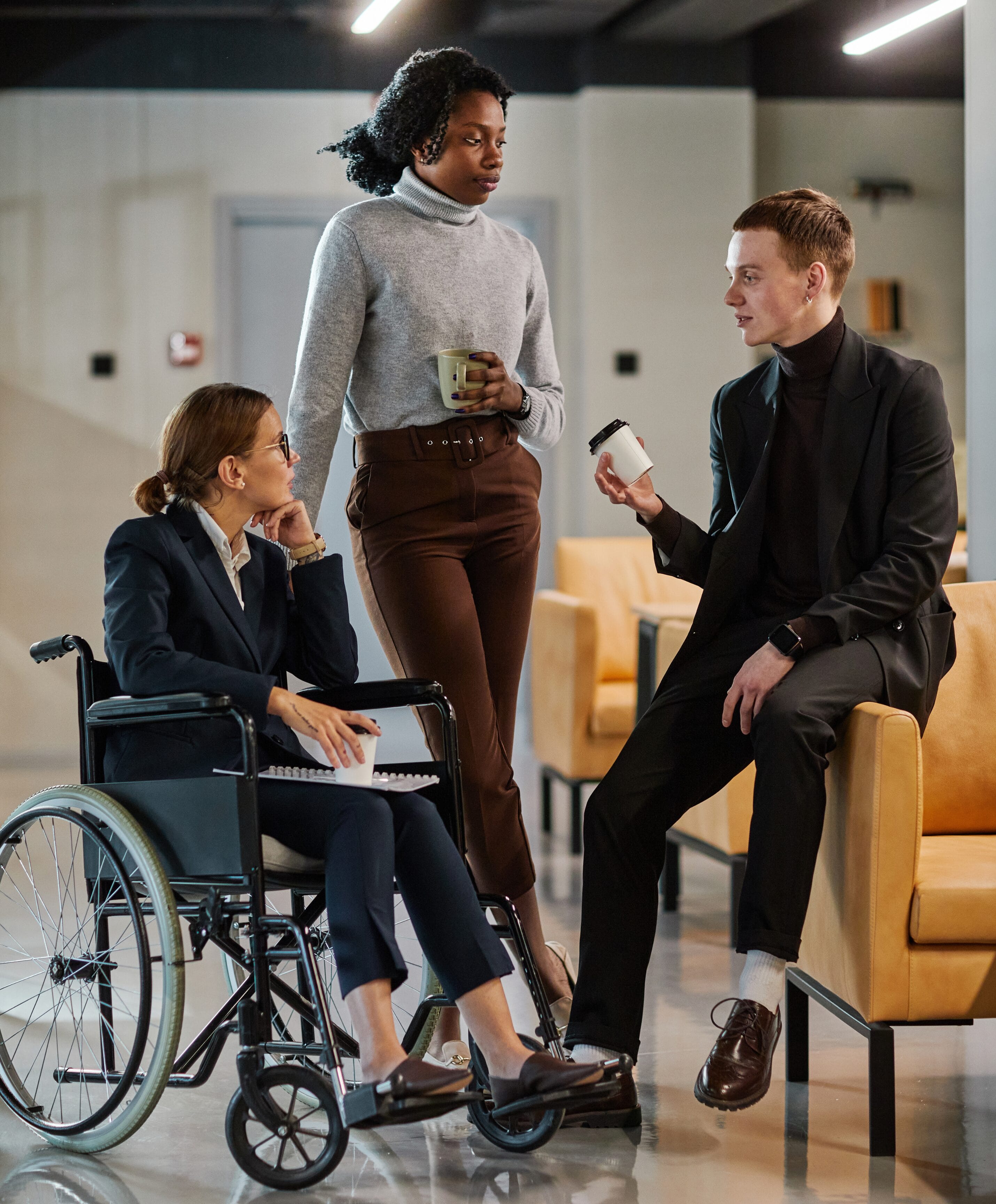 People talking in an office setting with a coffee